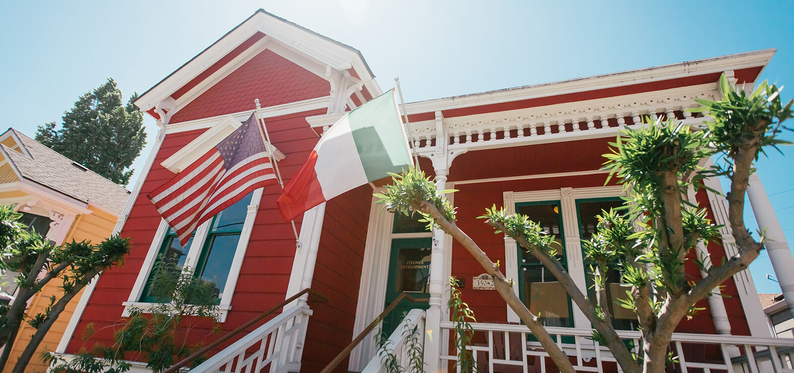 Charming houses adorned with Italian flags in San Jose's Little Italy, echoing the neighborhood's deep Italian roots and history.